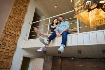 Middle-aged male and female are sitting on the second floor