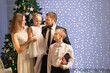 © Evgenia Tiplyashina - christmas family near christmas tree