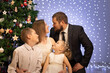© Evgenia Tiplyashina - christmas family near christmas tree