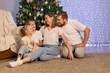 © Evgenia Tiplyashina - christmas family near christmas tree