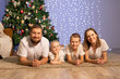 © Evgenia Tiplyashina - christmas family near christmas tree