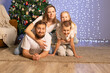 © Evgenia Tiplyashina - christmas family near christmas tree