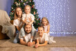 © Evgenia Tiplyashina - christmas family near christmas tree