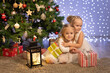 © Evgenia Tiplyashina - two babies under the tree with gifts