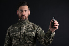 Soldier Holding Hand Grenade On Black Background. Military Service