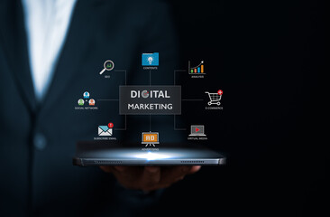 Wall Mural - Businessman holding tablet with online digital marketing technology icons. Increasing market share and profit by SEO, Advertising, E-commerce. Online marketing strategy, direct and sale network.