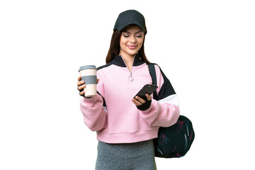 Wall Mural - Young sport woman with sport bag over isolated chroma key background holding coffee to take away and a mobile