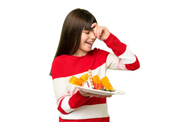 Canvas Print - Little girl holding waffles over isolated chroma key background laughing