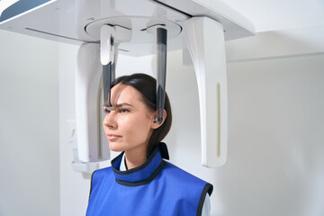 Wall Mural - Brunette woman is on a diagnostic procedure in X-ray room