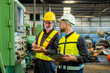 © BESTIMAGE - Two professional engineer worker technician assistant in helmet inspection check old machine construction factory with colleague manager. check old machinery production construction operating