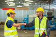 © BESTIMAGE - greeting by handshake touch fist and elbow of two engineer supervisor partnership in old factory. foreman greeting friend for good friendship colleague laborer in teamwork factory.