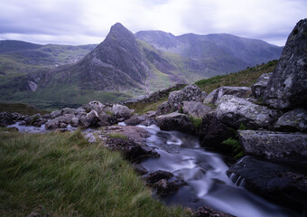 Above Llyn Ogwen.  View of pyramid shaped mountain.  Stream in foreground.  Long exposure silky smooth water.
