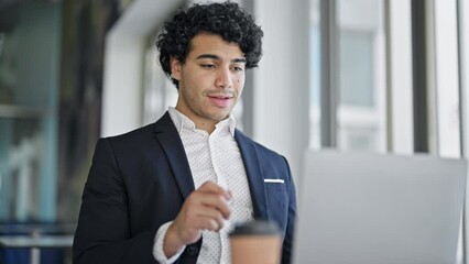 Poster - Young latin man real state agent having video call holding keys of new home at office