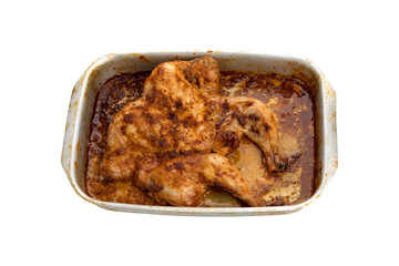 Wall Mural - Baked chicken on a baking sheet. Chicken baked in the oven on a baking sheet close-up isolated on a white background.