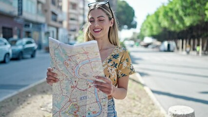 Sticker - Young blonde woman tourist smiling confident looking city map at street