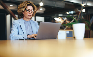 Wall Mural - Business woman working on a laptop in a coworking office