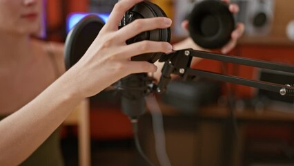 Poster - Young blonde woman musician wearing headphones singing song at music studio