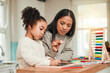 © Daniels C/peopleimages.com - Learning, math and mother help kid with homework for homeschool lesson, project or academic assignment. Smile, happy and parent or mom support child with education, development and studying together