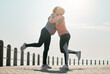 Running, hug and women by sea and ocean with love and care for fitness and exercise. Athlete, wellness and female friends on a beach promenade with motivation, embrace and smile from runner target