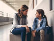 © AspctStyle - Sad student talking to her teacher for support. trust or counseling in the school hallway, for discussion or education about bullying, learning problems and development