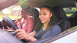 Teenage Girl In Car Having Driving Lesson From Female Instructor Or Parent