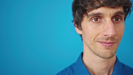 Poster - Young hispanic man smiling over isolated blue background