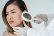 © Shisu_ka - skin problem and beauty of asian girl. specialist of skin use magnifying glass look itchy skin from skin allergic, steroid allergy, sensitive skin, chemical allergy, rash, insect bites, Dermatitis.