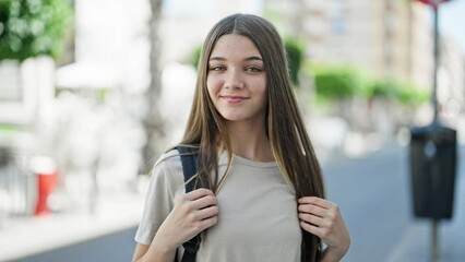 Poster - Young beautiful girl student smiling confident wearing backpack at street