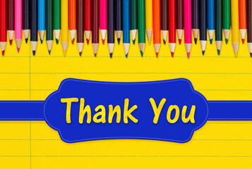 Wall Mural - Thank you message with color pencils crayons on yellow ruled line notebook paper