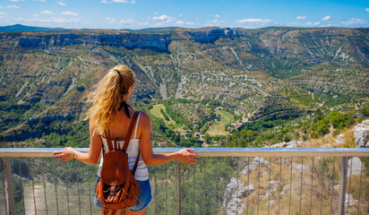 Wall Mural - Woman tourist enjoying panoramic view of France landscape- travel, tour tourism, adventure concept- Cirque de Navacelles, Herault, Larzac in France