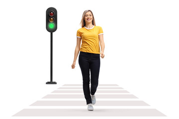 Sticker - Full length portrait of a young woman crossing a street and smiling