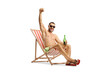 © Ljupco Smokovski - Man at a beach chair holding a bottle of beer and gesturing happiness