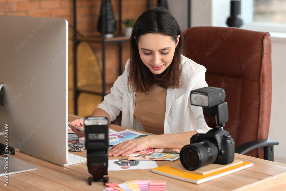 Female photographer working at table in studio