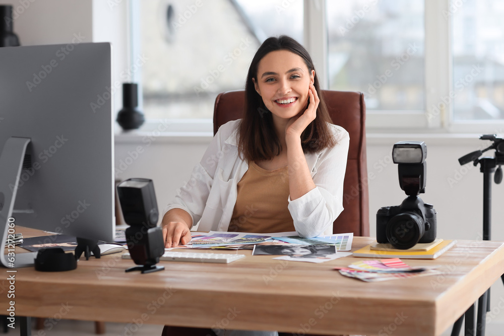 Female photographer working at table in studio