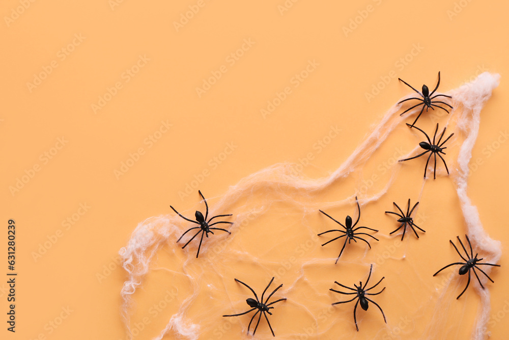 Cobweb with spiders for Halloween party on orange background