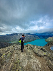 Wall Mural - Photographer admiring the amazing view of the Besseggen ridge, famous hiking spot in Jotunheimen National Park