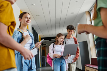 teenage girl and boy using laptop in school hallway, student life, teen classmates, school break