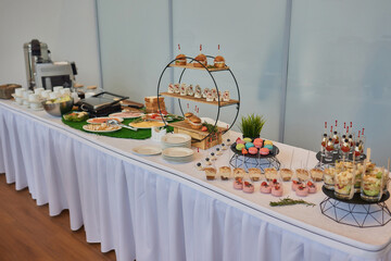 Different types of canapes on buffet table.