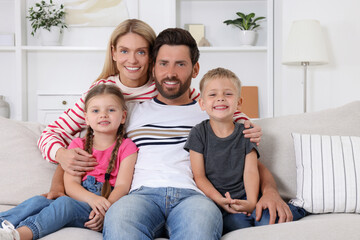 Wall Mural - Portrait of happy family with children on sofa at home