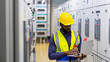 © CandyRetriever  - Industry factory manufacturing concept. African man engineer working on laptop computer in electric server control panel room. Industrial technician worker maintenance check power system in plant room