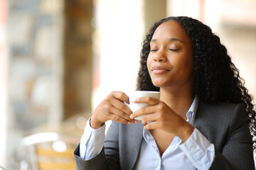 Executive relaxing drinking and breathing in a coffee shop