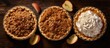A top-down photo of classic fall pies - pumpkin, pecan, and apple crumble - with room for text
