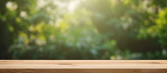 Leinwandbilder - A wooden table with a blank surface is placed against a blurry natural background. This space can