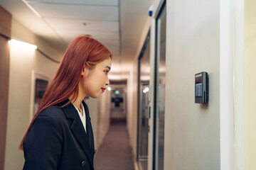 Businesswoman using face scanner to unlock door in office, Biometric admittance control device for security system.