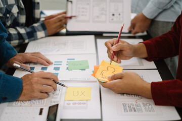 Creative male web designer planning application development for web mobile phone at modern workplace.