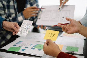 Creative male web designer planning application development for web mobile phone at modern workplace.