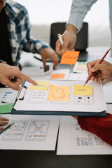 Creative male web designer planning application development for web mobile phone at modern workplace.
