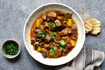 Canvas Print - Meat stew ( beef bourguignon ) with vegetable and mushrooms. Top view with copy space.