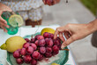 © Raquel - woman's hand holding a grape on a plate