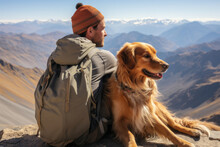 Male Hiker And His Pet Dog Admiring A Scenic View From A Mountain Top. Adventurous Young Man With A Backpack. Hiking And Trekking On A Nature Trail. Traveling By Foot.